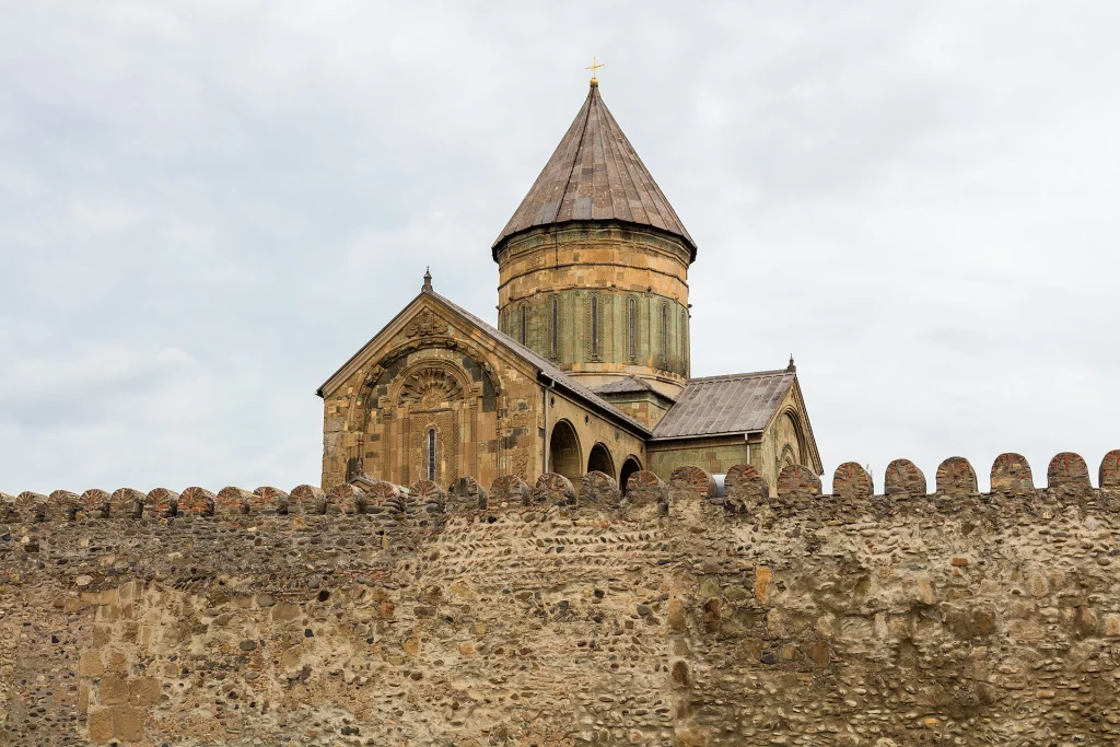 Svetitskhoveli Cathedral's dome and stone walls rising above Mtskheta's ancient fortifications.