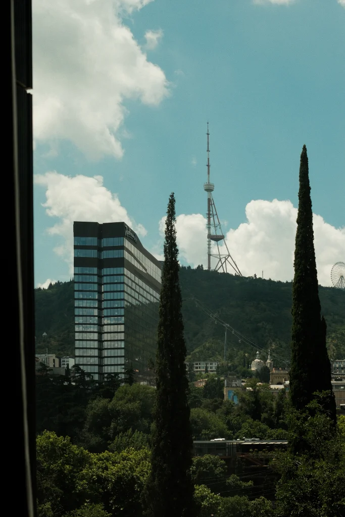 ART Riverfront Hotel Tbilisi — View from the hotel window overlooking Tbilisi's hills and TV tower.