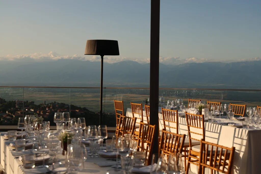 Bodbe Hotel — Outdoor dining terrace with mountain and valley views at sunset.