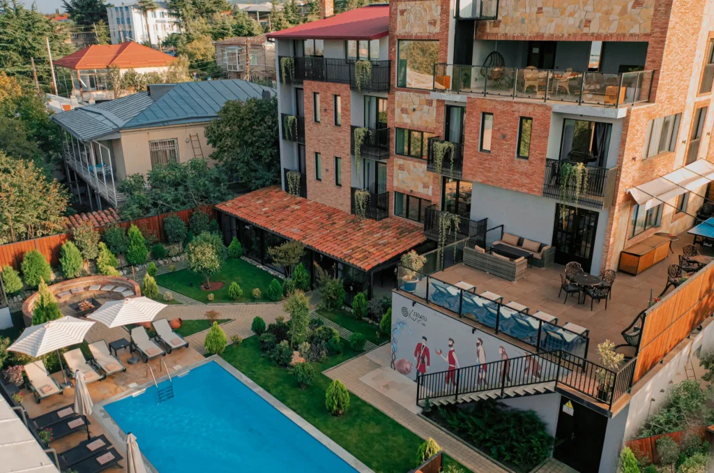 Boutique Hotel Kviria — Aerial view of the hotel building with pool, garden, and terrace seating areas.