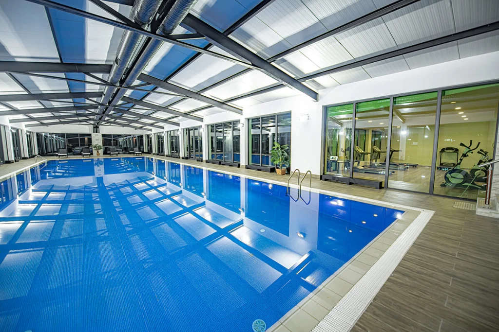 Crystal Hotel & Spa — Indoor swimming pool with glass roof and adjoining fitness area.