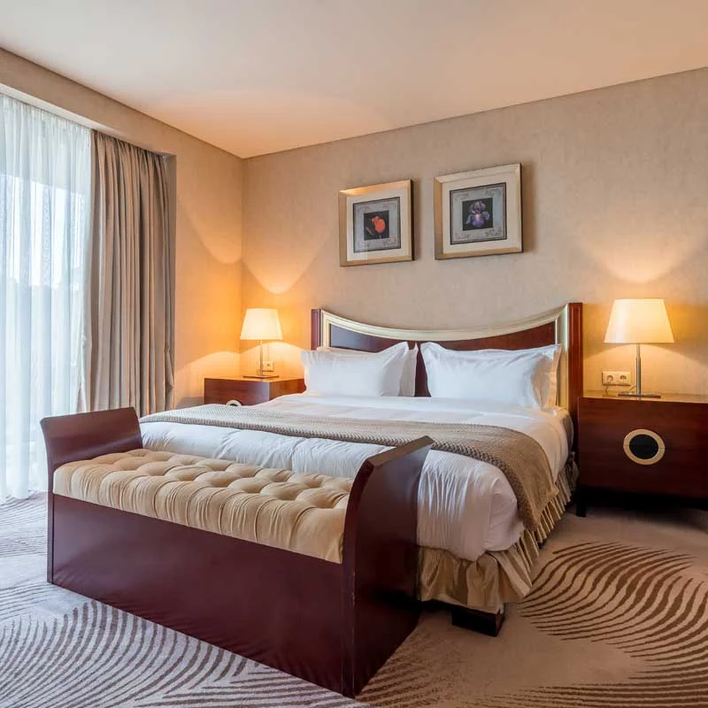 Dreamland Oasis Hotel — Elegant hotel bedroom with a large bed and warm lighting.