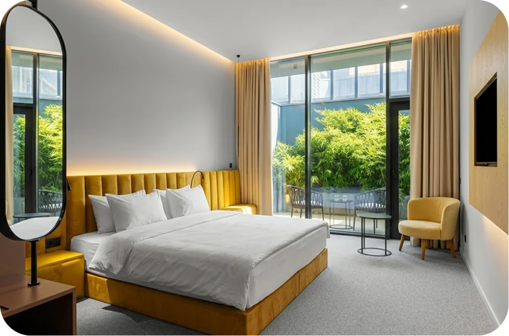 Episode Tbilisi — Hotel room with yellow upholstered bed and glass doors opening to a green terrace.