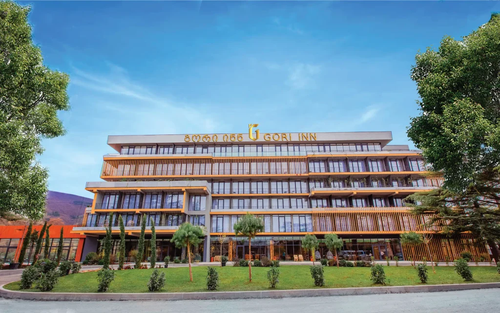 Gori Inn — Daytime view of the multi-story Gori Inn hotel building with landscaped front garden.