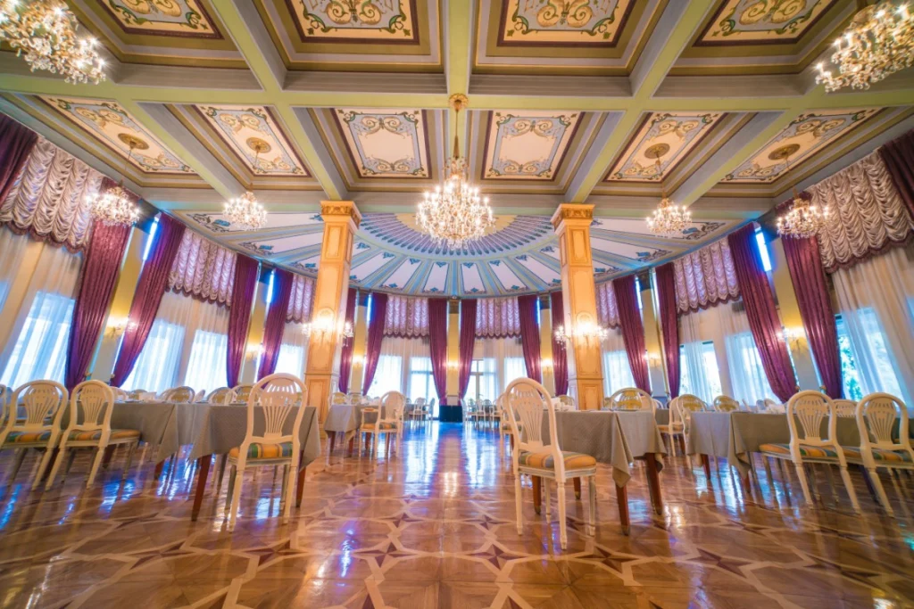 Hotel Intourist Palace — Elegant domed restaurant hall with chandeliers, painted ceiling, and formally set tables.