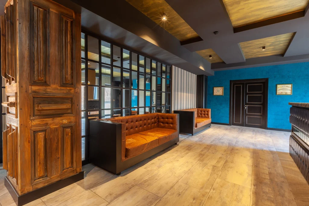Hotel Solomon — Hotel lobby seating area with leather sofas and teal accent wall.