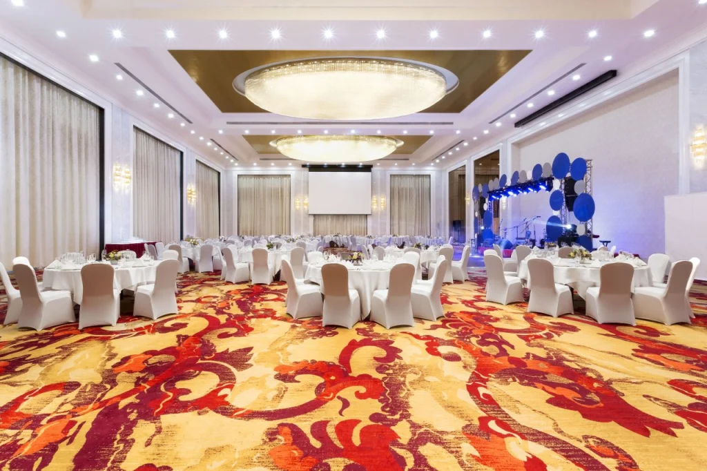 Hotels & Preference Hualing Tbilisi — Large hotel ballroom set up with round tables for a formal event.