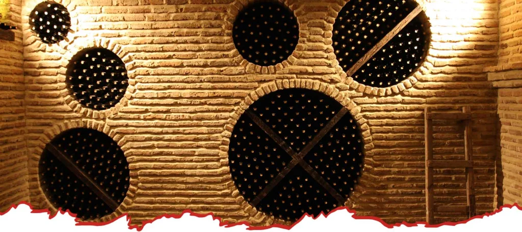 Kerovani Winery — Traditional clay qvevri vessels embedded in a brick cellar wall.