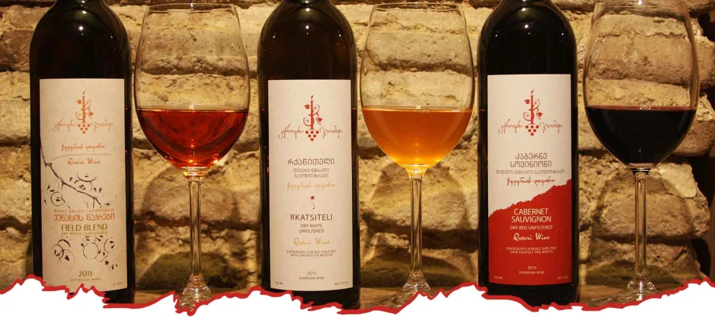Kerovani Winery — A wine tasting flight of three glasses alongside their bottles on display.