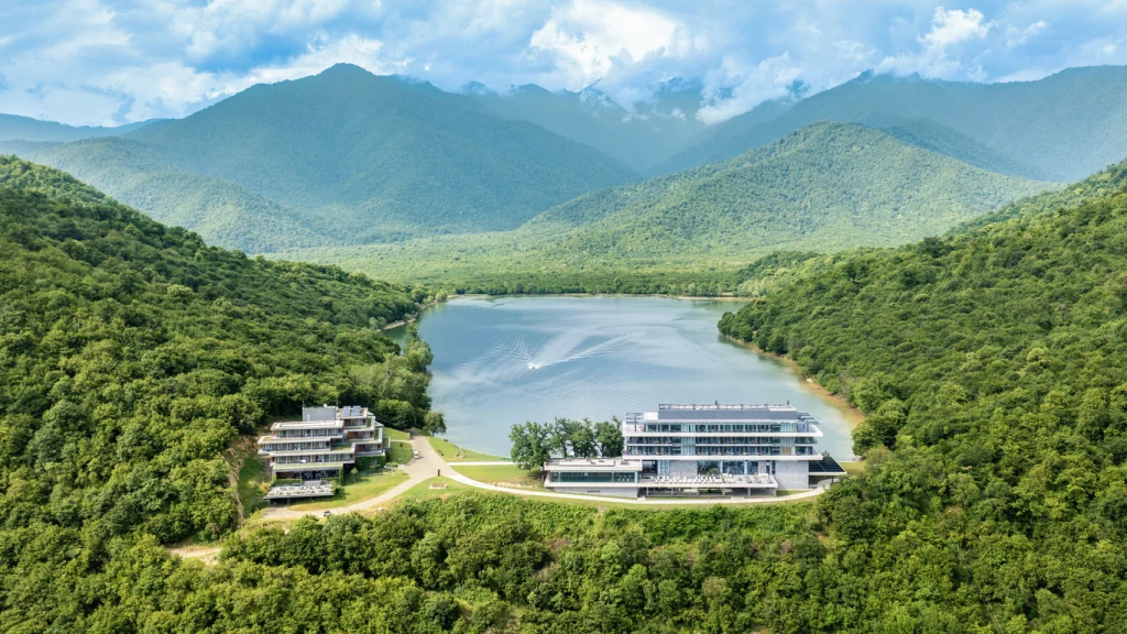 Kvareli Lake Resort — Aerial view of the resort buildings nestled by Kvareli Lake surrounded by forested mountains.