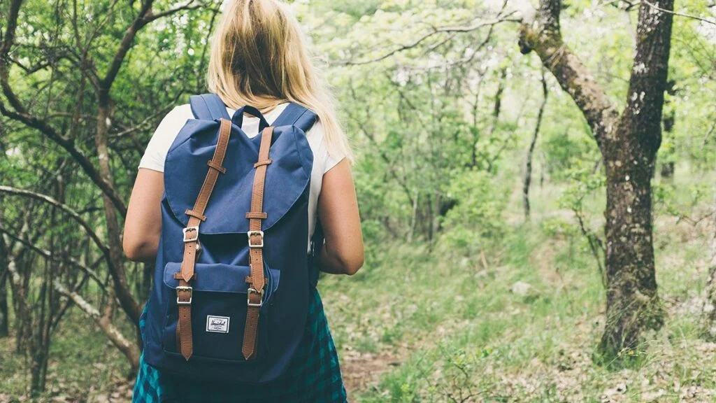 Lost Ridge Inn, Brewery and Ranch — A person with a backpack walks along a wooded trail near the property.
