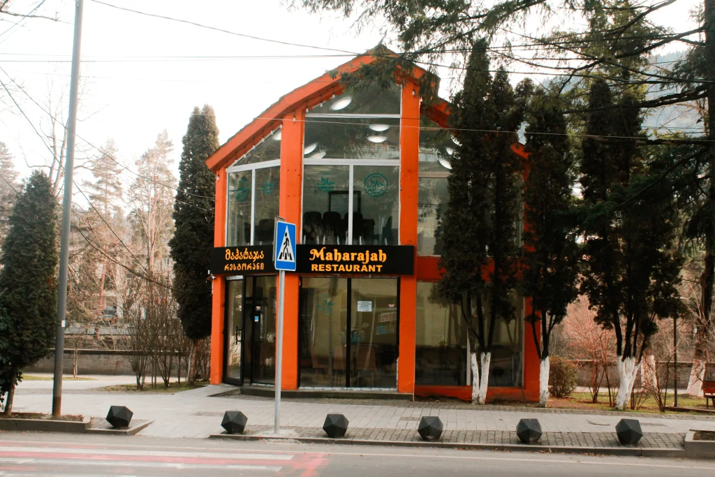 Maharajah Restaurant (Tbilisi) — Street-facing exterior of the restaurant with distinctive orange-framed glass facade and signage.