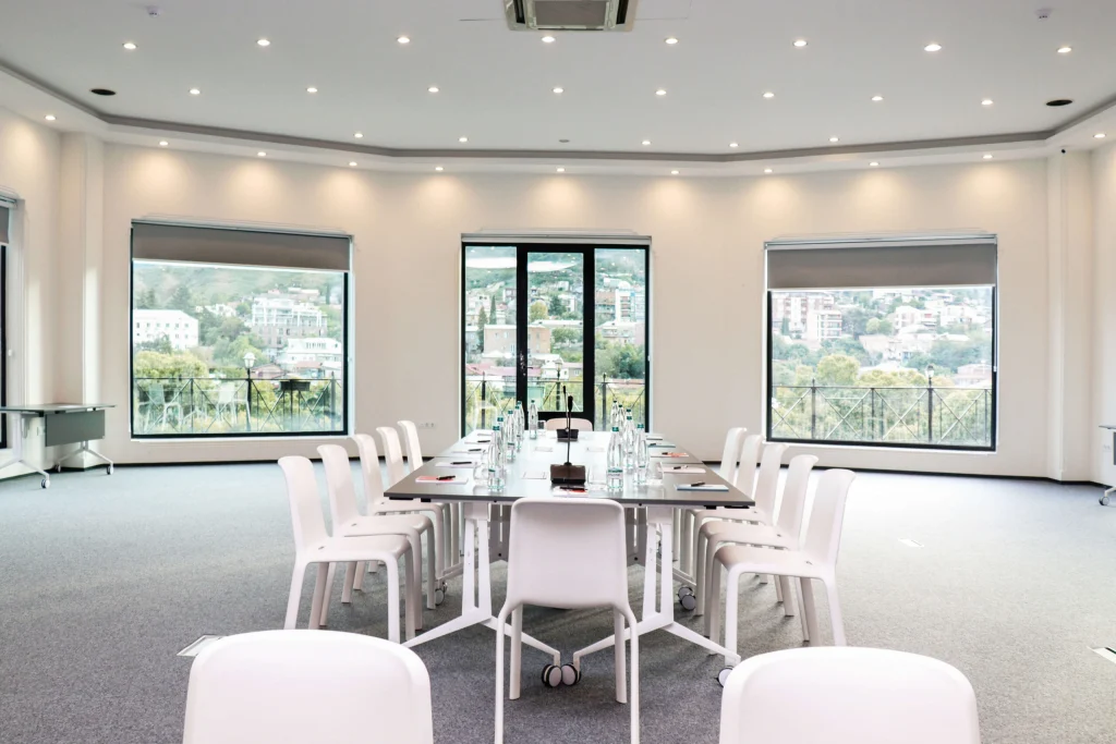 Margot Old Tbilisi — Meeting room with large windows offering views over the surrounding hillside city.