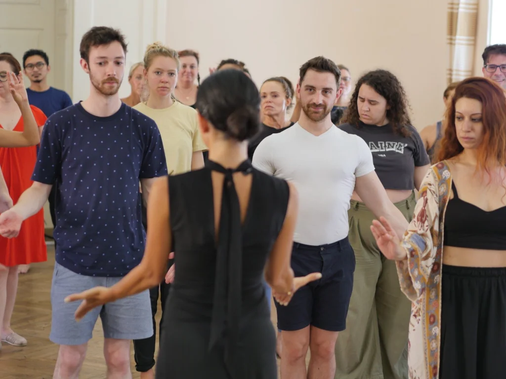 Melita Dance Studio — Dance instructor leads a group class in a bright studio room.