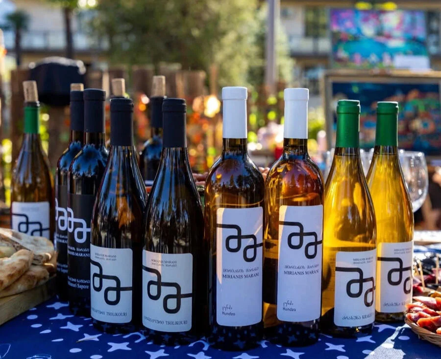 Mirianis Marani — Assortment of Mirianis Marani wine bottles displayed outdoors on a table.