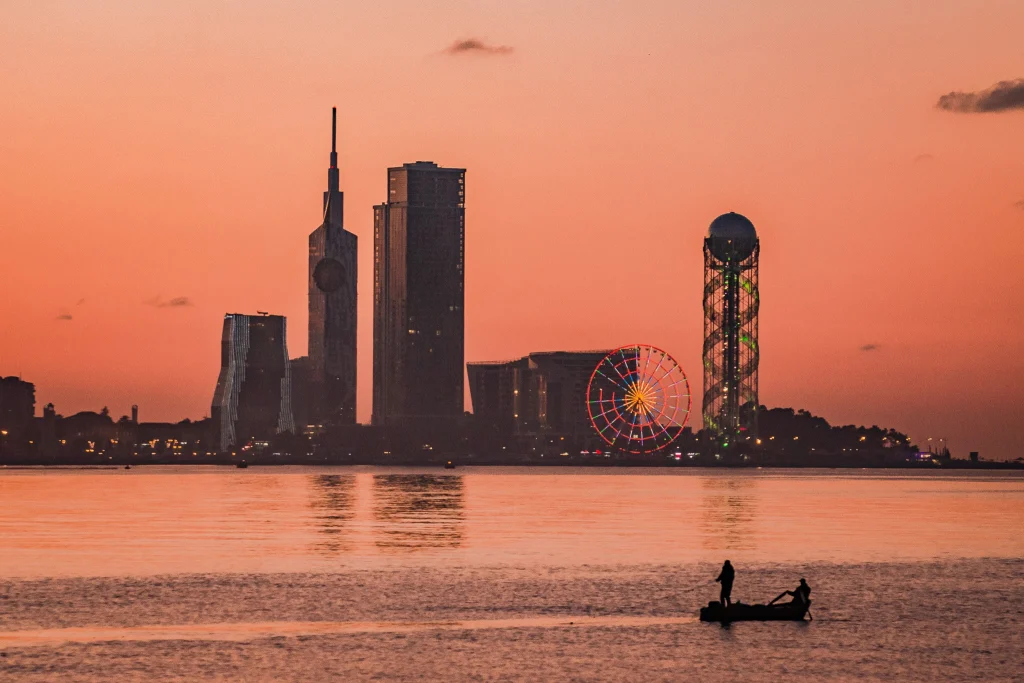 Orbi Residence Hotel — Sunset skyline view across the water showing city towers and a ferris wheel.
