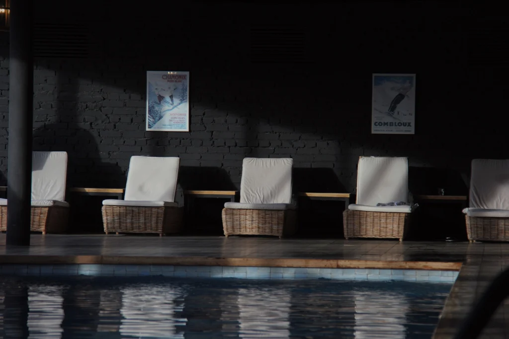 ROOMS Kazbegi — Indoor pool area with wicker loungers and ambient lighting.