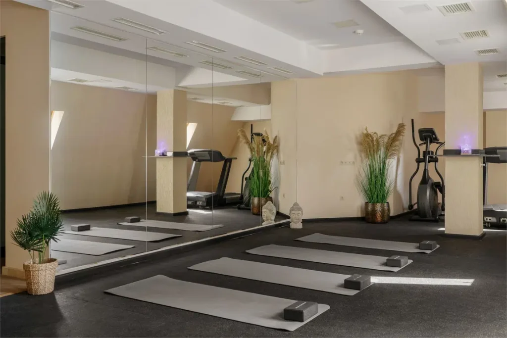 Sephia — Hotel fitness studio with yoga mats, mirrors, and cardio equipment.
