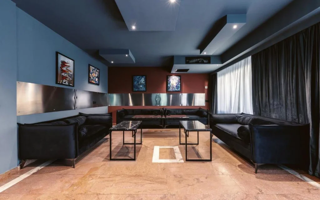 Splendid Tbilisi — Lounge seating area with dark sofas and black coffee tables.