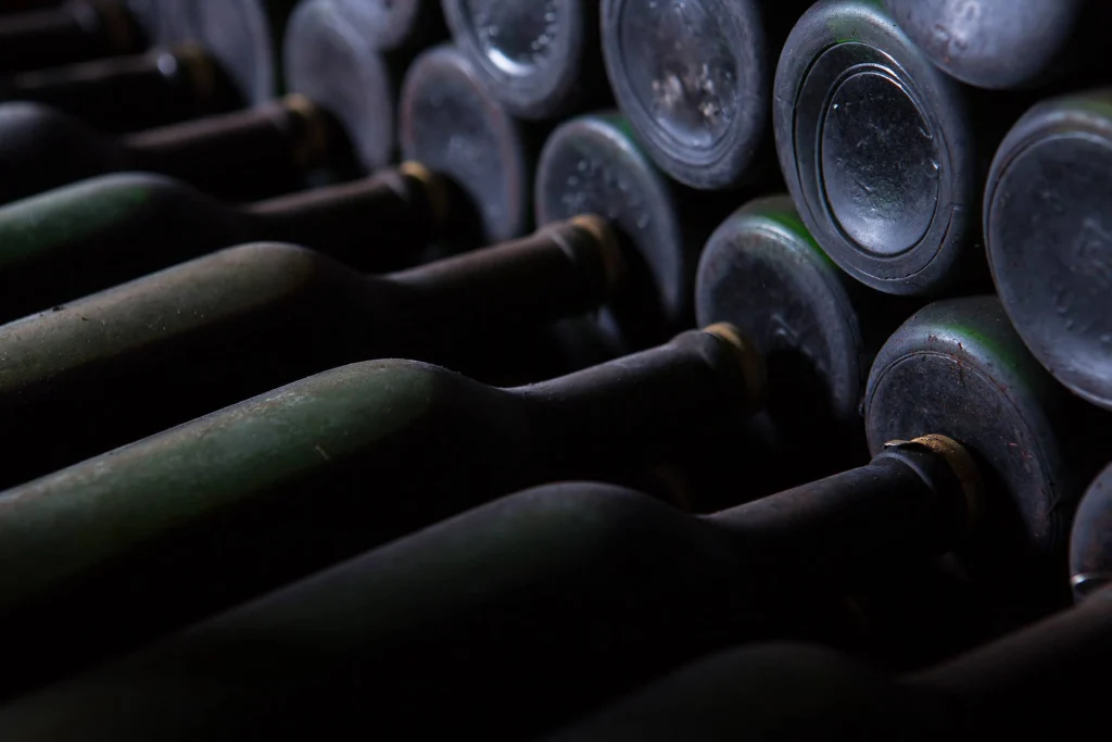 marani naturalisti — Rows of aged wine bottles stacked in a dim cellar at the property.