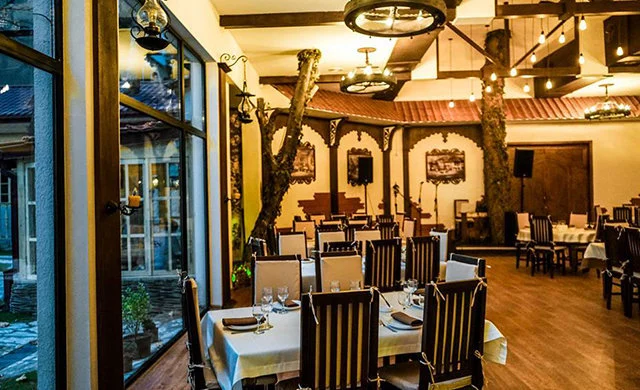 sormoni — Indoor restaurant area with wooden beams, set tables, and warm ambient lighting.