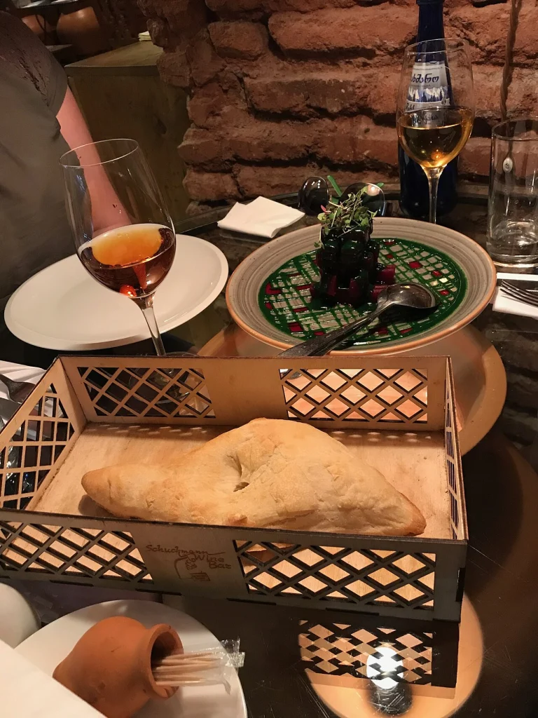 Georgian bread and dishes served with wine during a 2017 trip to Georgia.