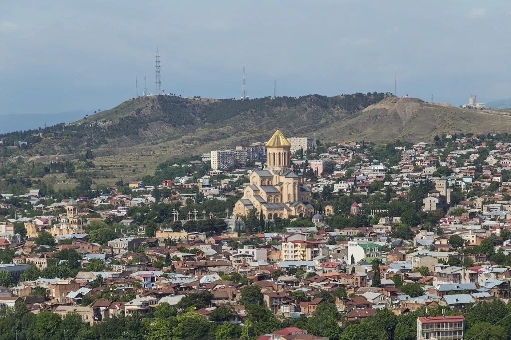 Panoramic view of Tbilisi with the Holy Trinity Cathedral rising above the cityscape.