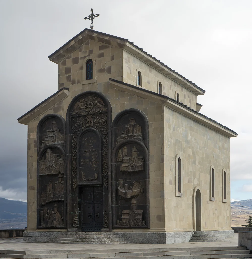 Church of the Annunciation with bronze relief doors at the Chronicle of Georgia monument site.