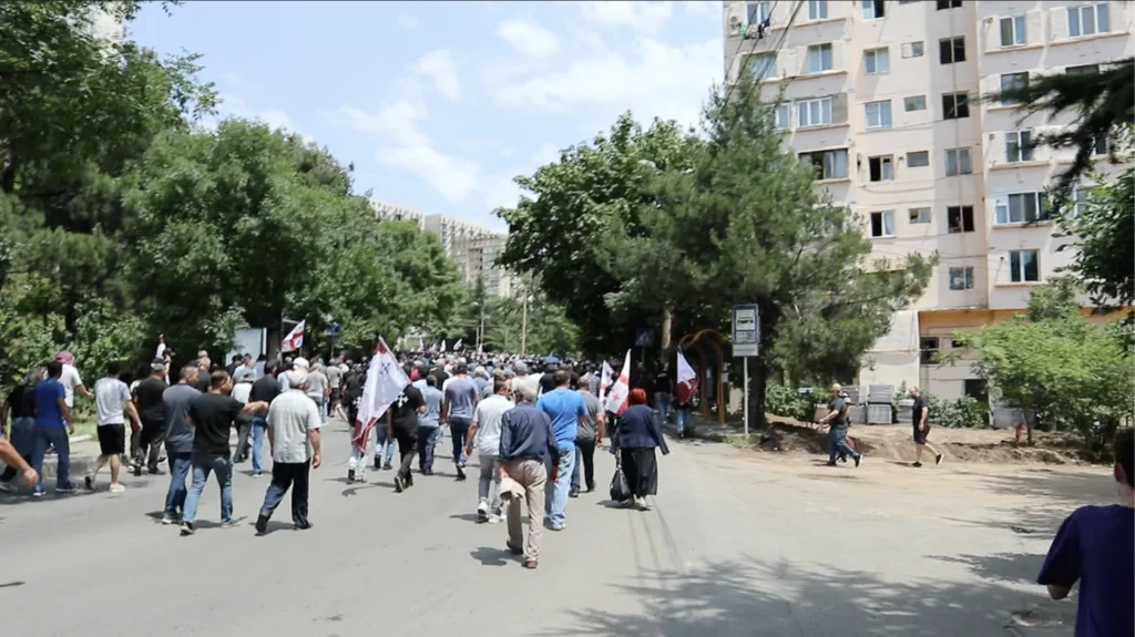 Crowds of far-right and ultranationalist demonstrators march with flags against Tbilisi Pride.