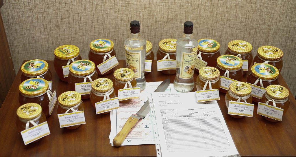 Jars of Georgian honey and honey vodka, the signature products celebrated at the festival.