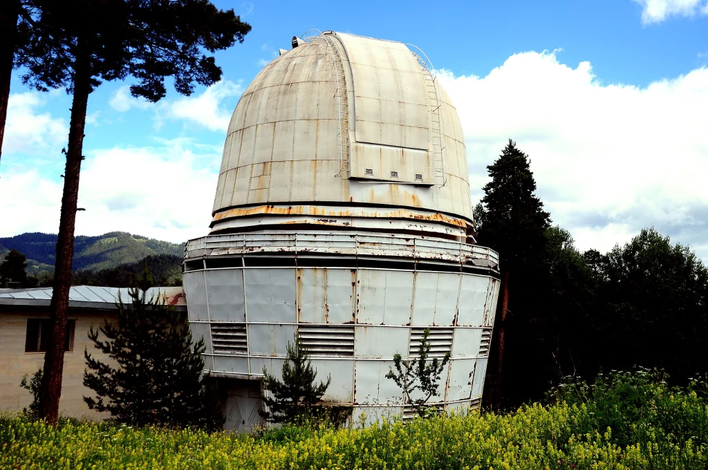 Full view of an observatory dome at Abastumani, Georgia, surrounded by hills.