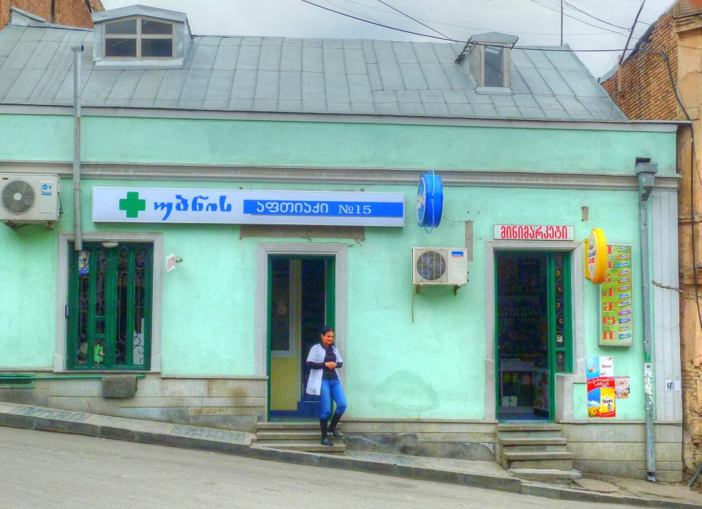 A neighbourhood pharmacy sign in Tbilisi, useful for travelers needing medication or advice.