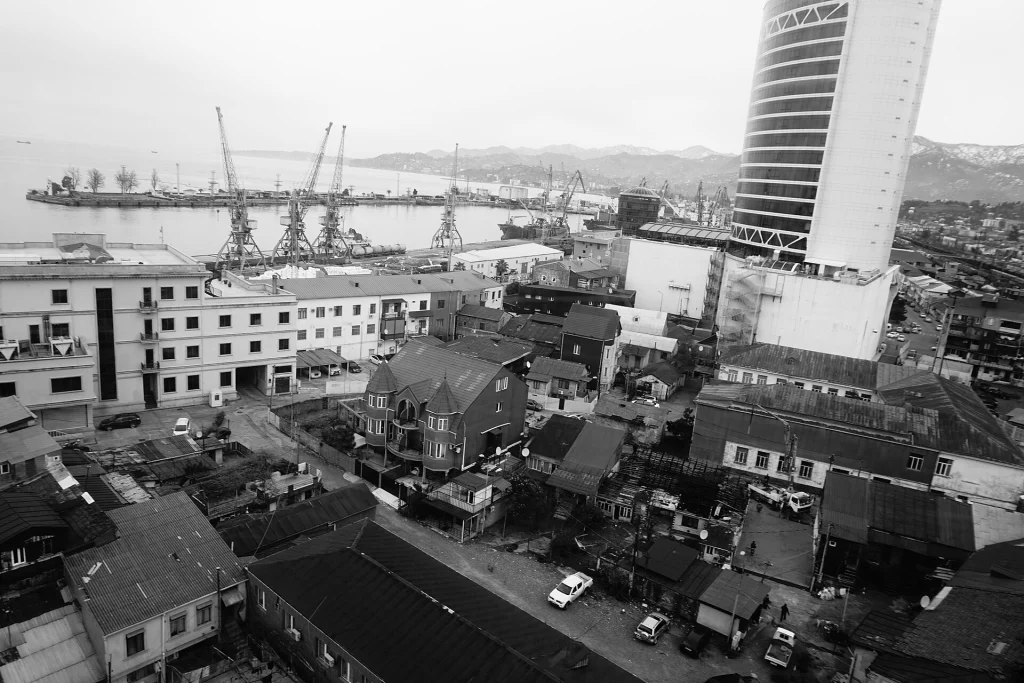 Batumi cityscape with port cranes, illustrating the urban hub for Adjara travel.