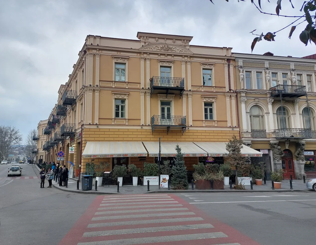 A typical Tbilisi street corner with restaurants and shops reflecting everyday urban practicalities.