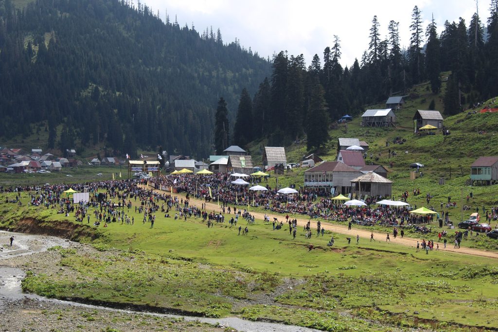 Festival crowds and tents fill the valley at Bakhmaro during the Peristsvaleba horse race.