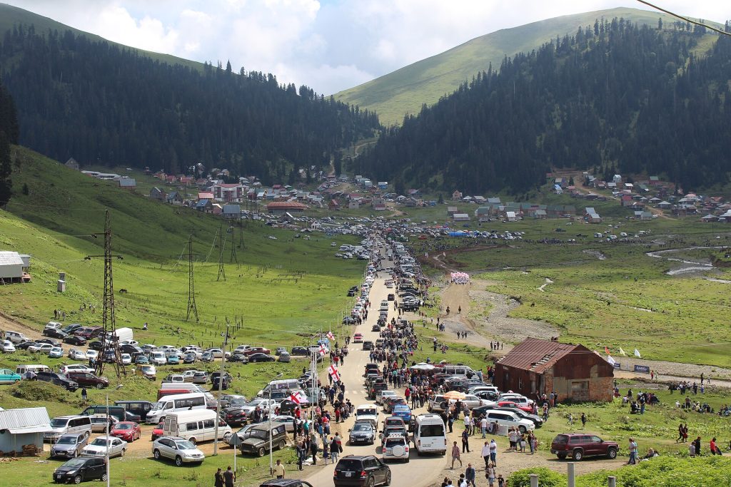Cars and spectators line the main road into Bakhmaro on horse racing day.