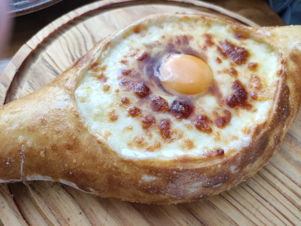 Adjarian khachapuri with a baked egg, a familiar yet distinct comfort food for travellers.