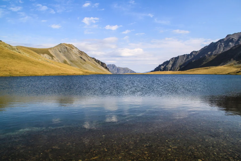 Black Rock Lake viewed across still water toward a dramatic mountain valley in Lagodekhi.