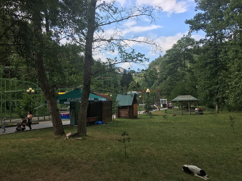 Visitors stroll past stalls and pavilions in Borjomi Central Park, the festival's main venue.