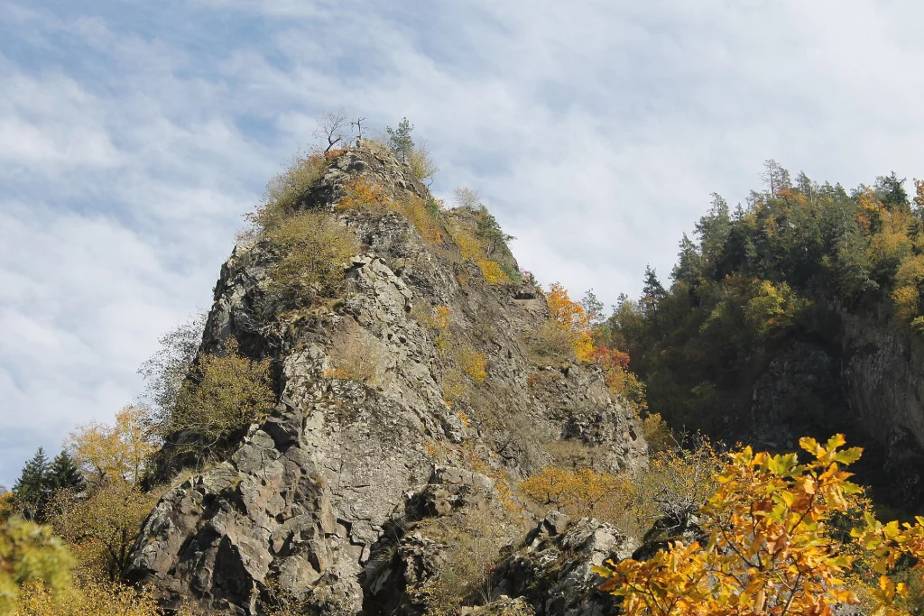 Rocky forested peak with autumn foliage in Borjomi-Kharagauli National Park.