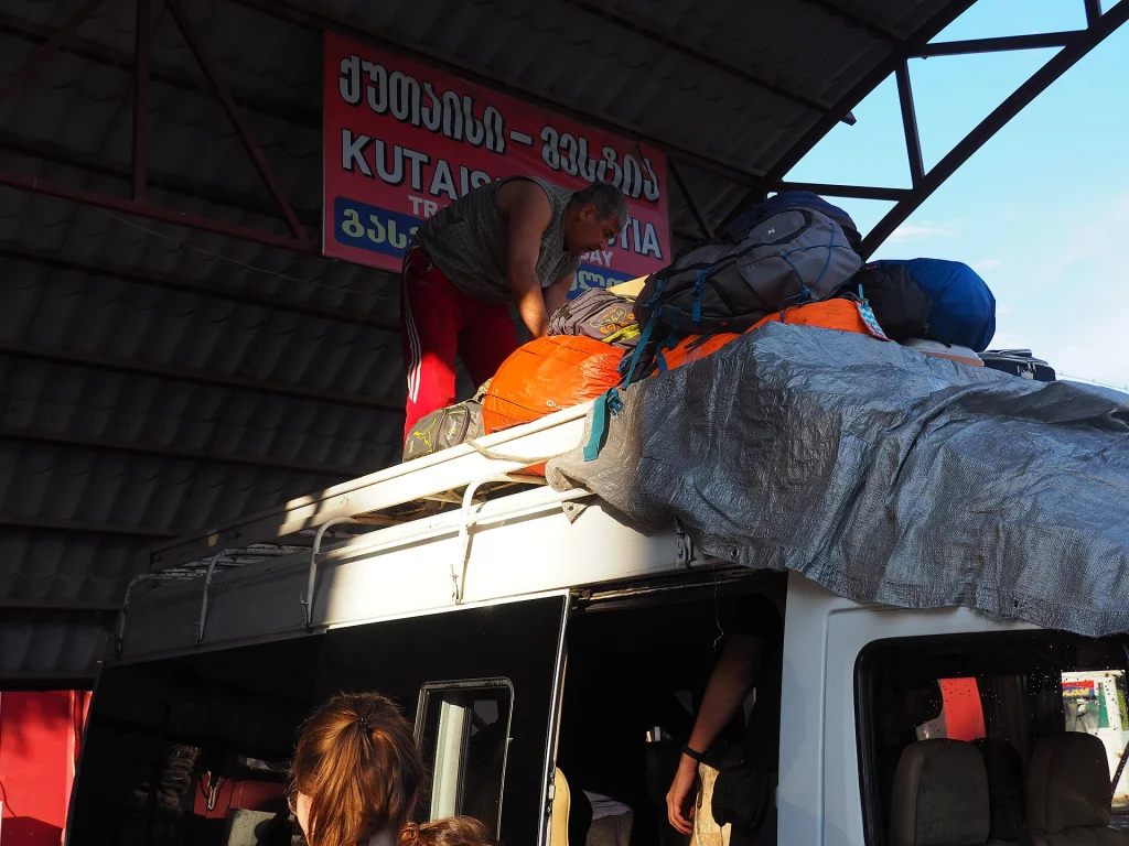 A bus loading luggage at Kutaisi central bus station bound for Mestia.