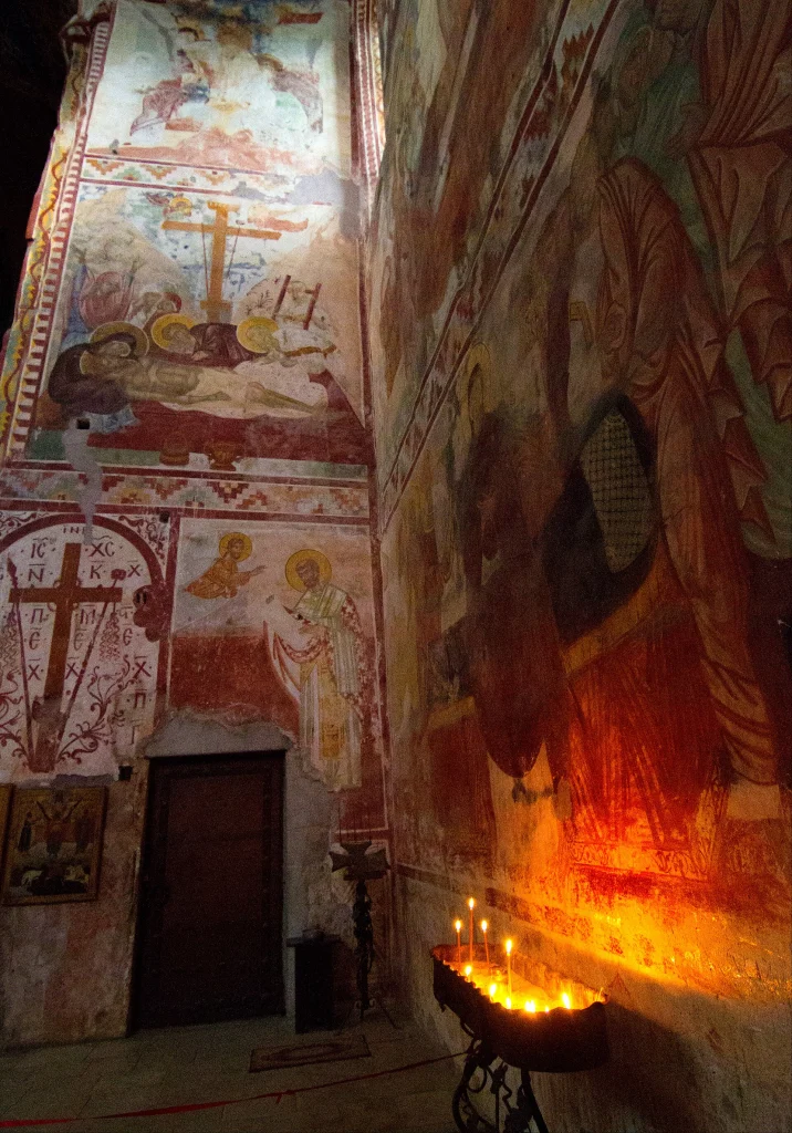 Candlelit frescoes inside Gelati Monastery, a UNESCO World Heritage Site near Kutaisi.