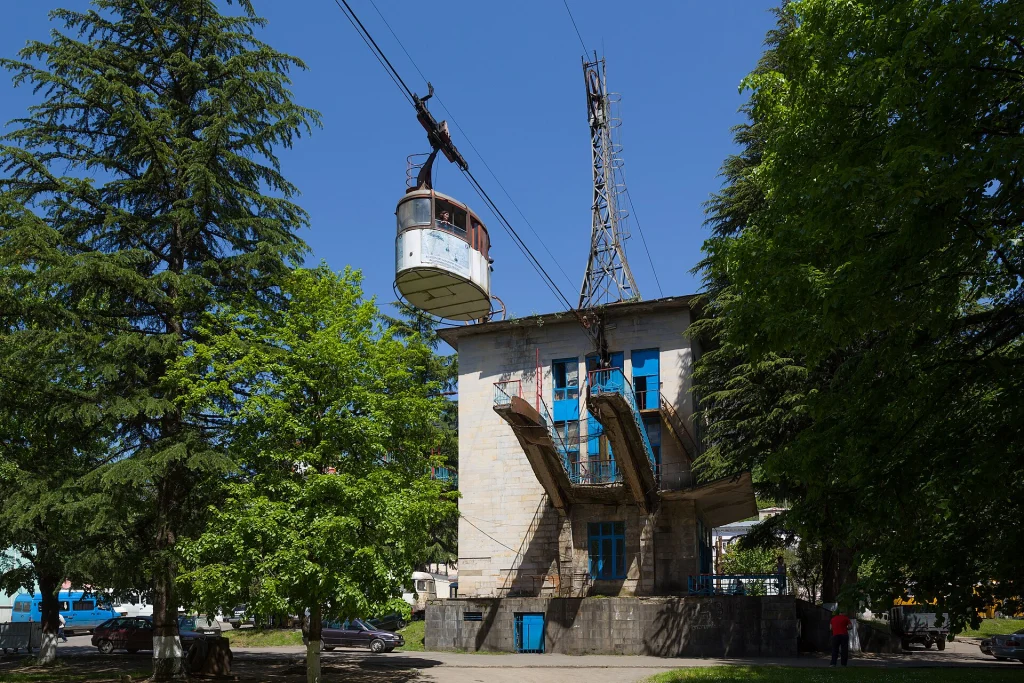 A vintage Soviet-era cable car glides above the streets of Chiatura.