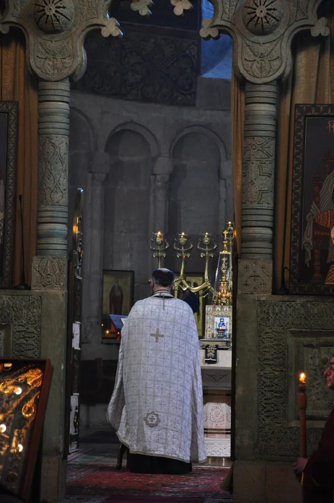 A priest conducts the liturgy before the altar, reflecting service times and customs to observe.