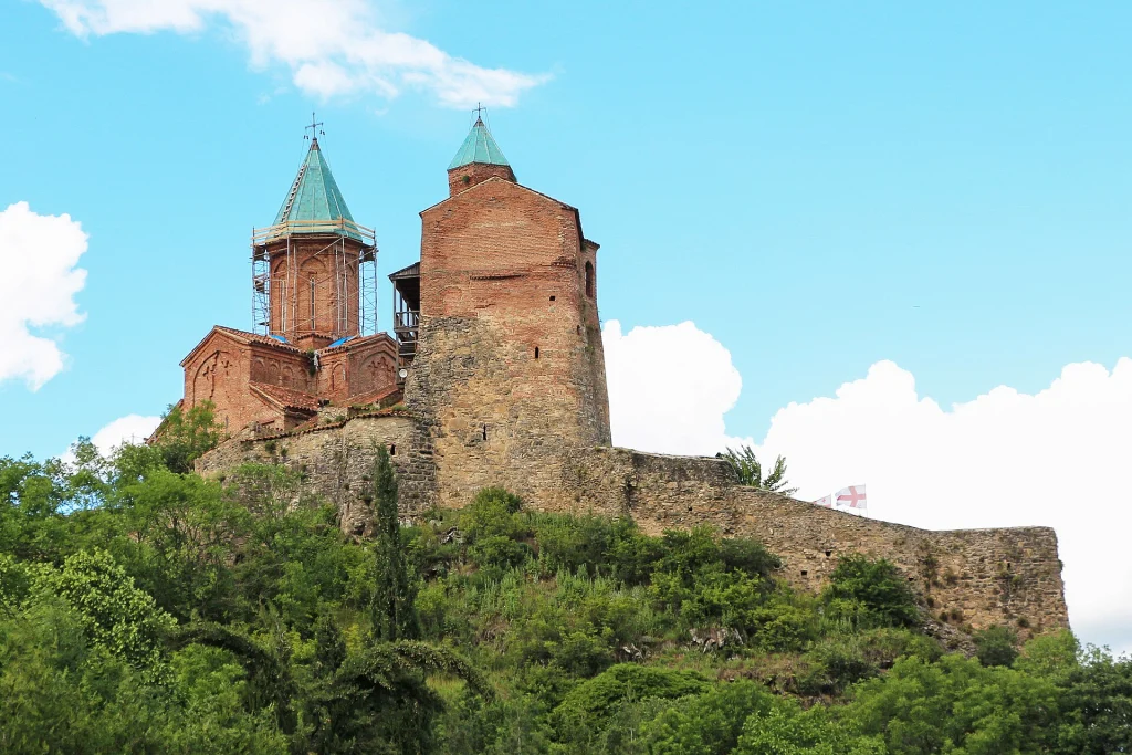 The Citadel of Gremi with its blue-domed church and tower rising above green hills.