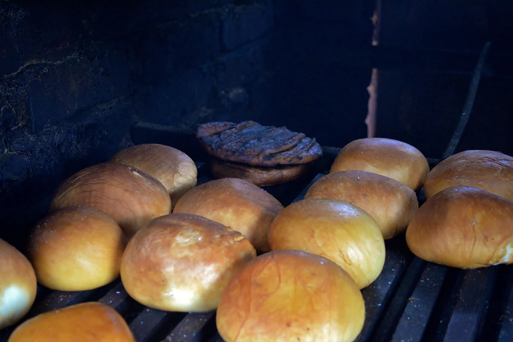 Rounds of sulguni cheese being smoked in a traditional home smokehouse in Svaneti.