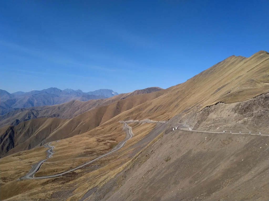 Winding dirt road over Datvisjvari Pass through the Greater Caucasus mountains.