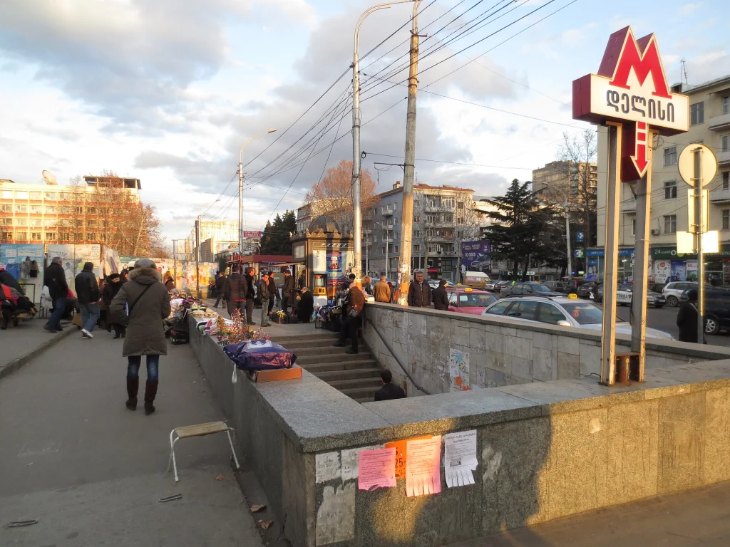 Delisi metro entrance with street vendors, illustrating Tbilisi's low-cost metro transport.