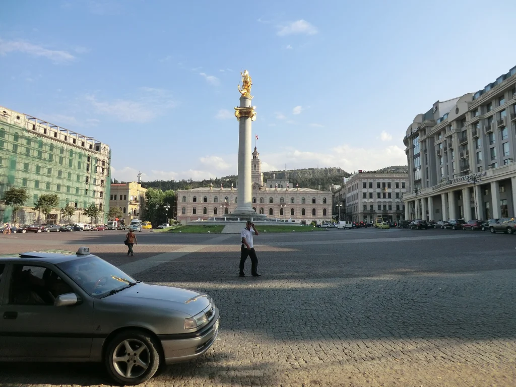 A taxi parked in Tbilisi's historic Freedom Square, a common spot where visitors hail cabs and consider tipping drivers.