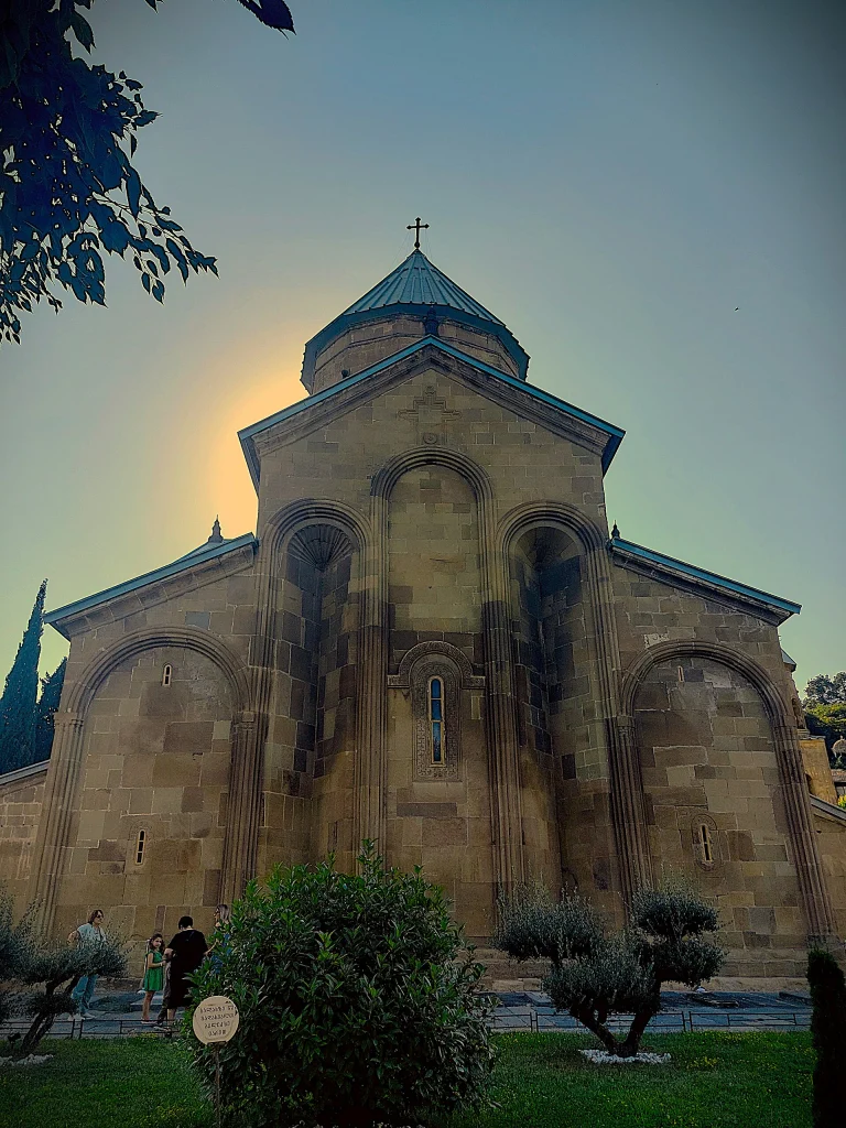 The east facade of Samtavro Monastery's main church glows at sunset in Mtskheta.